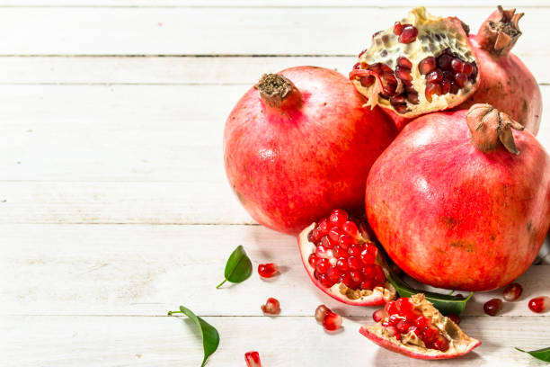 istock Ripe pomegranates with leaves. 900572866