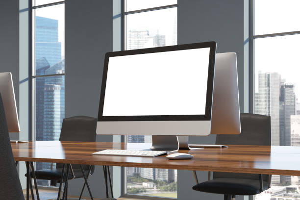 istock White computer screen on a wooden desk 900575518