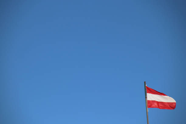 istock Austrian Flag flutters in the Blue Sky 900575826
