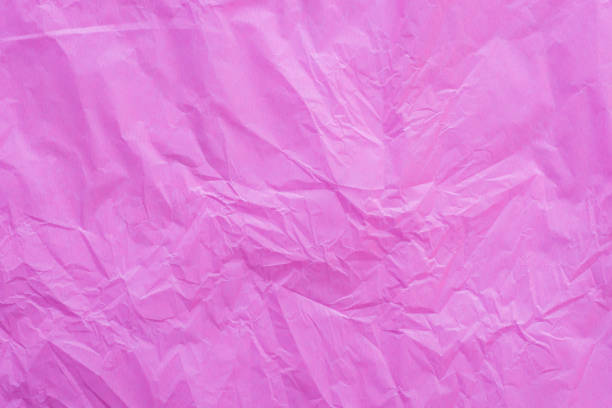istock pink creased paper tissue background texture 900576090