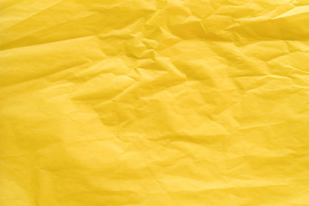 yellow creased paper tissue background texture stock photo