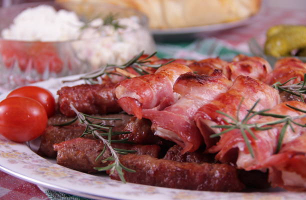 istock Chicken meat wrapped in bacon and cevapcici 900581236
