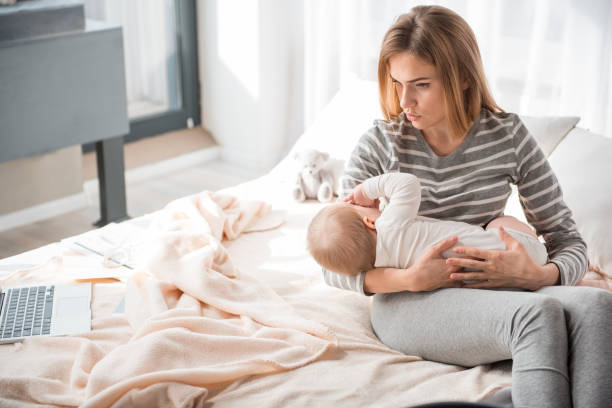 istock Tired mother calming crying kid 900587742