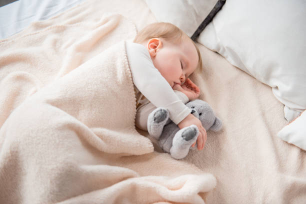 istock Cute infant dreaming with toy 900587978