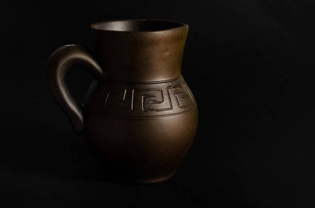 istock Clay jug, old ceramic vase on black background 900588320