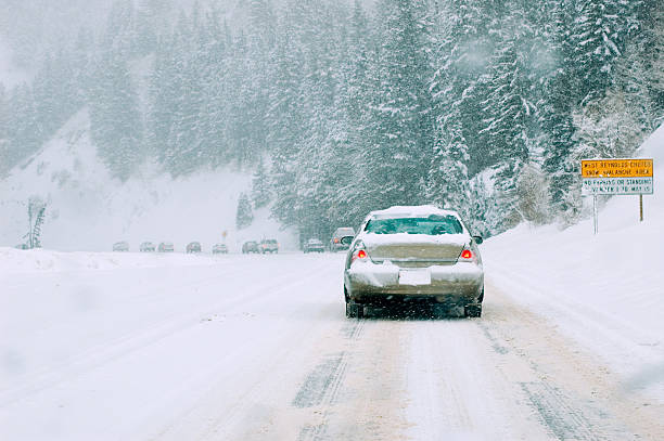 istock Mountain road in snow storm 90059287
