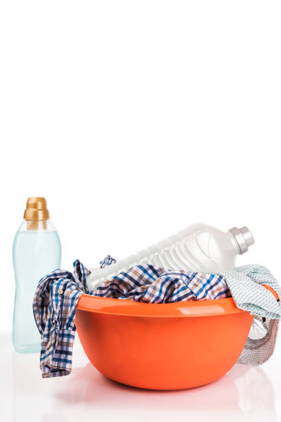 Dirty clothes and detergent isolated on white background