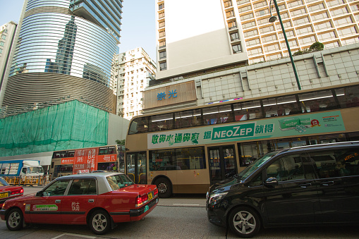 Hong Kong S.A.R, China - December 30, 2017: Double-decker public buses, cars and taxis at Canton Road street, Kowloon peninsula;