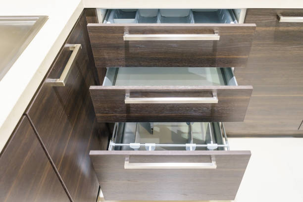 Opened kitchen drawer with plates inside, a smart solution for kitchen storage and organizing