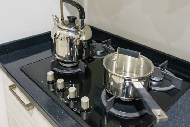 istock Metal Pot on induction hob in modern kitchen. modern kitchen pot cooking induction electrical stove hob concept 900607486