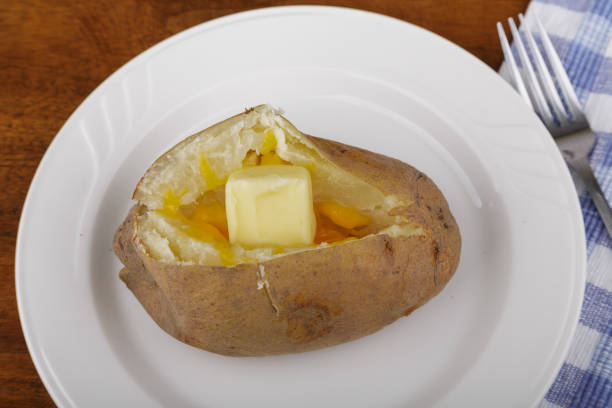 istock Butter and Cheese Melting in Baked Potato 900607630