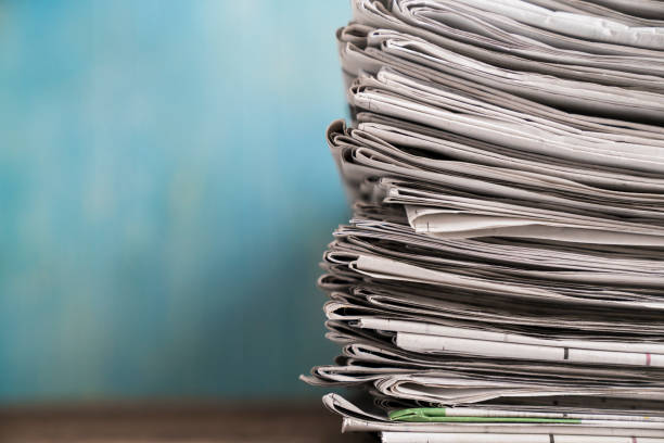 istock close up newspapers folded and stacked background on the table 900607980