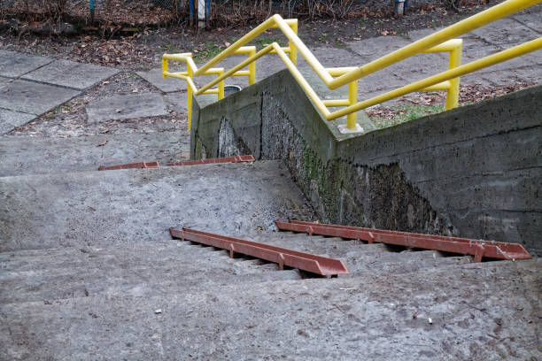 istock Cement grunge stone stairs with rusty handicapped rails 900610940