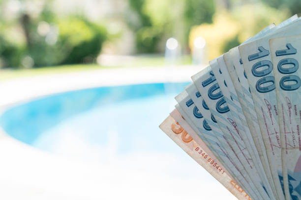 Travel Expenses Female Holds Turkish Lira Near By Pool at Summer Time Bozcaada Turkey 2017 stock photo