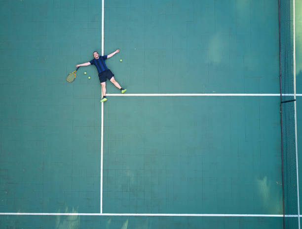 istock Tennis player tired after game 900612452