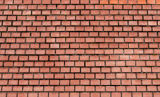 Brick wall close-up. It can be seen laying bricks.