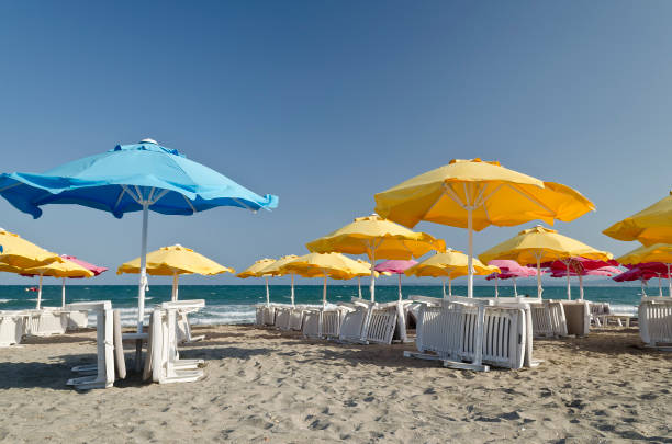 istock Colorful Beach Umbrellas against the blue sky 900619344