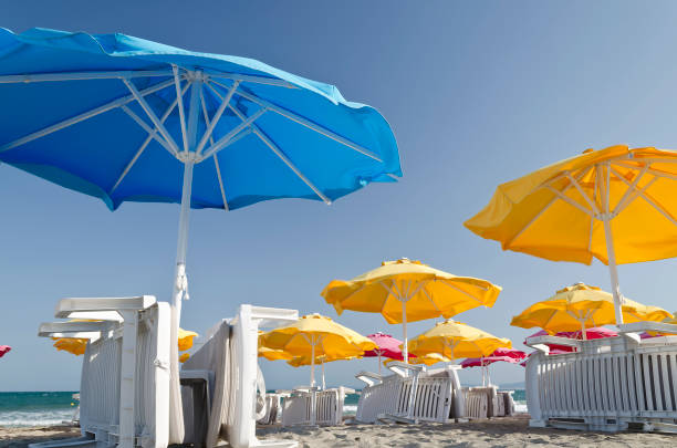 istock Colorful Beach Umbrellas against the blue sky 900619454
