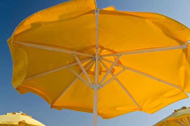 istock Colorful Beach Umbrellas against the blue sky 900619548