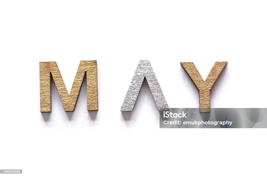 MAY  - may written in gold and silver lettering gold and silver wooden letters positioned neatly to make abbreviations of the months of the year Abbreviation Stock Photo