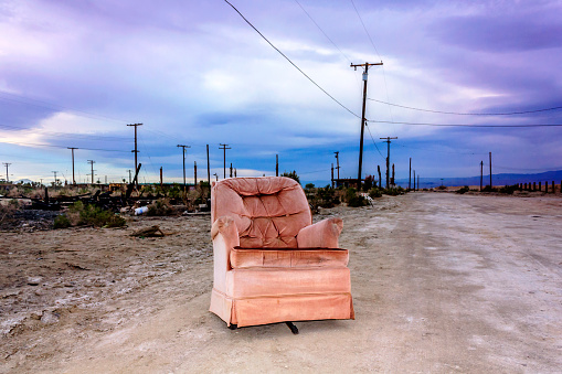 Old armchair outside in Salton City, California, United States.
