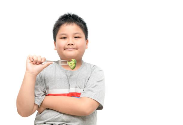 istock obese fat boy with broccoli on hand isolated 900626126
