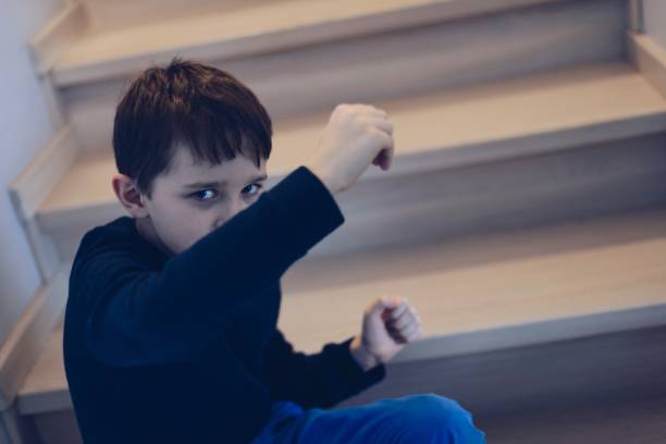 istock Sad frightened child covering his face from hit 900636942