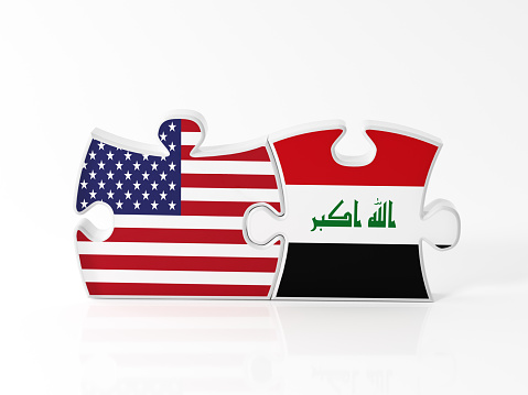 Jigsaw puzzle pieces textured with American and  Iraqi flags on white. Horizontal composition with copy space. Clipping path is included.
