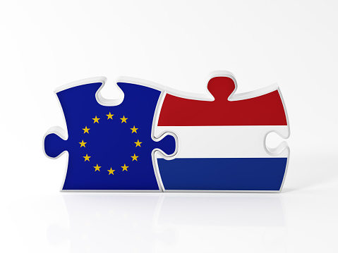 Jigsaw puzzle pieces textured with European Union and Dutch flags on white. Horizontal composition with copy space. Clipping path is included.