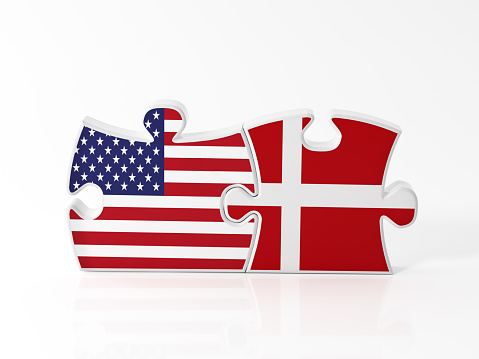 Jigsaw puzzle pieces textured with American and Danish flags on white. Horizontal composition with copy space. Clipping path is included.