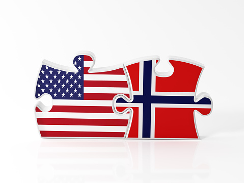 Jigsaw puzzle pieces textured with American and  Norwegian flags on white. Horizontal composition with copy space. Clipping path is included.