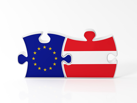 Jigsaw puzzle pieces textured with European Union and Austrian flags on white. Horizontal composition with copy space. Clipping path is included.