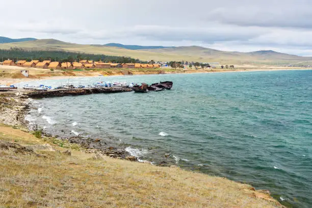 View of Pier with ships and beach in Khuzhir Village on Olkhon Island, Siberia, Russia