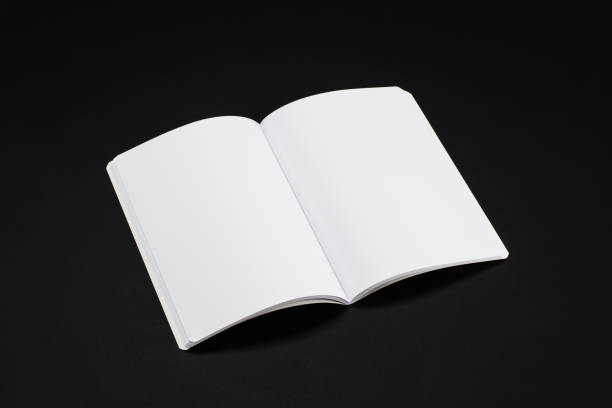 istock Mock-up magazines, book or catalog on black table background. 900658334