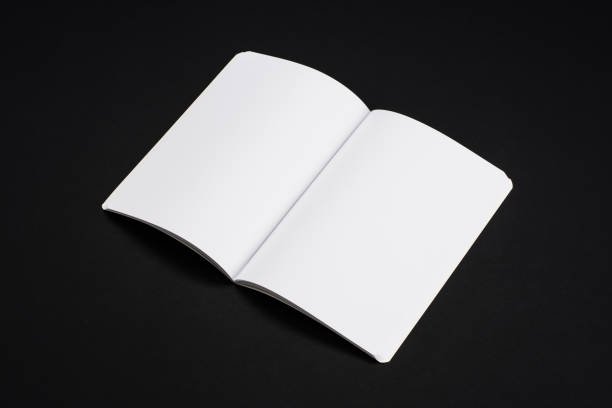 istock Mock-up magazines, book or catalog on black table background. 900659540