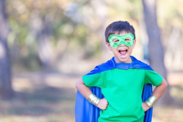 istock Little boy pretending to be superhero 900664866
