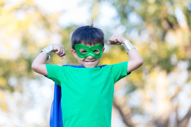 istock Little superhero flexes his muscles 900664892