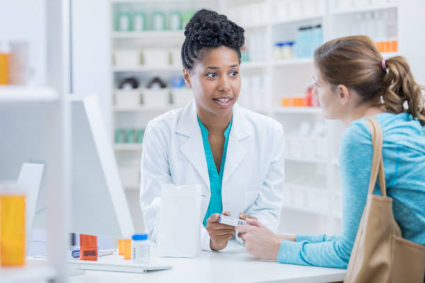 istock Professional pharmacist assisting customer with questions in pharmacy 900665172