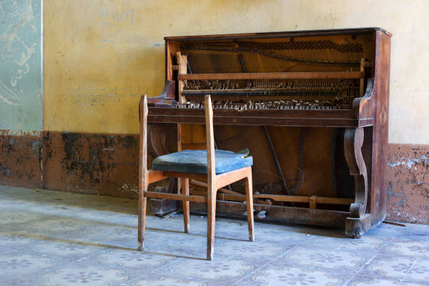Abandoned piano and broken chair