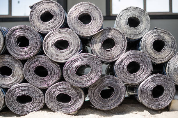 istock Rolls of new black roofing felt 900672958