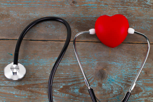 istock Stethoscope with red heart on a wood background 900685396