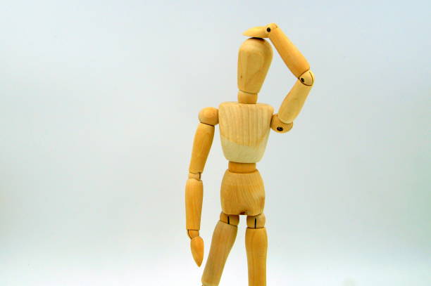 istock figure hand to head - bad idea 900688120