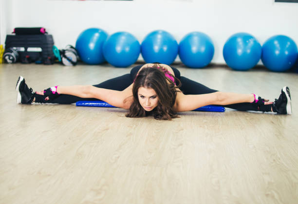 istock woman stretching her leg in 180 leg split position 900691880