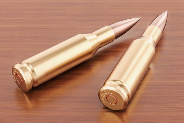 istock Bullets on the wooden table. 3D rendering 900695722