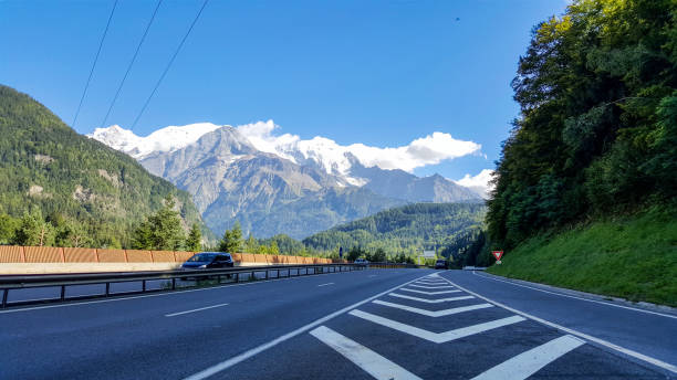 istock A road to mountains with nice view at rock. 900696116