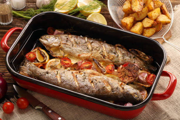 istock Baked fish with vegetables and potatoes 900700126