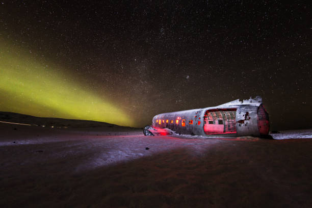 istock Solheimasandur plane wreck with active norhtern lights, Iceland 900703164