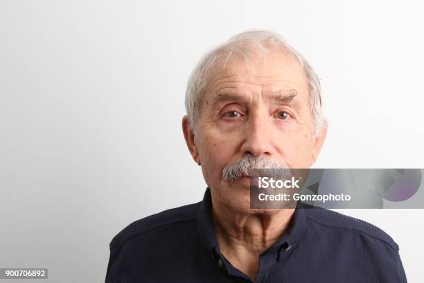 An Old Man Looking At Camera With A Serious Facial Expression Stock Photo - Download Image Now