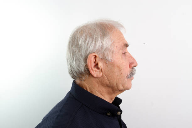 A right side profile shot of an old man on white background