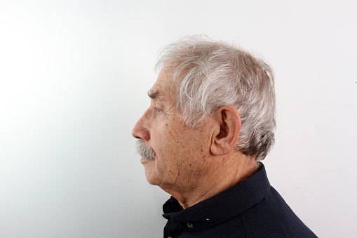 A left side profile shot of an old man